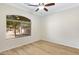 Bright bedroom featuring wood-look flooring and an updated ceiling fan at 21299 E Roundup Way, Queen Creek, AZ 85142