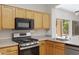Well-equipped kitchen features stainless steel appliances and ample counter space at 21299 E Roundup Way, Queen Creek, AZ 85142