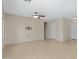 Spacious living room with tile flooring, multiple doorways, and a blank wall ready for personalization at 21299 E Roundup Way, Queen Creek, AZ 85142