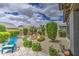 Lush backyard showcasing manicured landscaping, a rock water feature, Adirondack chairs, and serene outdoor space at 21711 E Arroyo Verde Dr, Queen Creek, AZ 85142