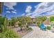 Picturesque backyard with a patio, Adirondack chair, manicured landscaping, flowering plants, and open space at 21711 E Arroyo Verde Dr, Queen Creek, AZ 85142