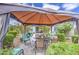Relaxing backyard with a covered patio, outdoor dining set, a manicured lawn, and flowering plants for a tranquil retreat at 21711 E Arroyo Verde Dr, Queen Creek, AZ 85142