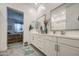 Modern bathroom with double sinks, granite countertops, stylish fixtures, and an open view to the main bedroom at 21711 E Arroyo Verde Dr, Queen Creek, AZ 85142