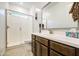 Well-lit bathroom featuring a sleek glass-enclosed shower, modern vanity, and a large mirror for a spa-like experience at 21711 E Arroyo Verde Dr, Queen Creek, AZ 85142