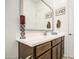A charming bathroom with a framed mirror, wood vanity, and modern faucet with ample counter space at 21711 E Arroyo Verde Dr, Queen Creek, AZ 85142