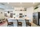 Spacious kitchen featuring an island with bar seating, white cabinets, and pendant lighting at 21711 E Arroyo Verde Dr, Queen Creek, AZ 85142