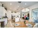Open kitchen features white cabinets, stainless appliances, a large island, and easy access to the dining area at 21711 E Arroyo Verde Dr, Queen Creek, AZ 85142