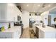 Beautiful kitchen featuring white cabinets, quartz countertops, stainless steel appliances, and a stylish backsplash at 21711 E Arroyo Verde Dr, Queen Creek, AZ 85142