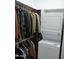 Efficient laundry closet with stacked washer/dryer unit and ample storage for clothing at 21711 E Arroyo Verde Dr, Queen Creek, AZ 85142