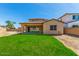 Expansive backyard with green grass, covered patio, and ample space for outdoor activities at 2365 N Springfield St, Buckeye, AZ 85396