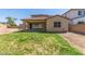 A well-maintained backyard with a patio and lush green grass at 2365 N Springfield St, Buckeye, AZ 85396
