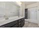 Bright bathroom with a double sink vanity, large mirror, and a shower-tub combination with a curtain at 2365 N Springfield St, Buckeye, AZ 85396