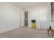 Cozy bedroom featuring neutral carpet and an open floor plan with doors, allowing for versatile furniture arrangements at 2365 N Springfield St, Buckeye, AZ 85396