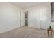 A bright bedroom with neutral carpet and an open doorway leads to an additional room at 2365 N Springfield St, Buckeye, AZ 85396