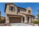 Inviting two-story home featuring a tile roof, attached two-car garage, and covered entryway at 2365 N Springfield St, Buckeye, AZ 85396