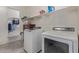 Well-organized laundry room equipped with modern washer and dryer units and built in shelving with a view to the closet at 2365 N Springfield St, Buckeye, AZ 85396