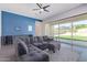 Cozy living room featuring a sectional sofa, large sliding glass doors, and stylish tile floors at 2365 N Springfield St, Buckeye, AZ 85396