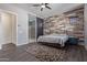Relaxing main bedroom with hardwood floors, accent wall, and ensuite bathroom with shower at 2365 N Springfield St, Buckeye, AZ 85396