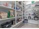 Walk-in pantry with lots of shelving for food storage, featuring a variety of household appliances and items at 2365 N Springfield St, Buckeye, AZ 85396