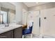 Bright bathroom features a vanity, an enclosed shower, and tile floors at 23730 W Hess Ave, Buckeye, AZ 85326