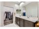 Modern bathroom features double sinks, white countertops, and a walk-in closet at 23730 W Hess Ave, Buckeye, AZ 85326