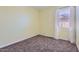 Bedroom with neutral carpeting, yellow walls, and a window that allows ample natural light in at 23730 W Hess Ave, Buckeye, AZ 85326