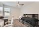 Cozy bedroom featuring neutral colors, a ceiling fan, and a stylish bed frame with built-in storage and shelves at 23730 W Hess Ave, Buckeye, AZ 85326