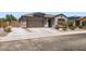 Charming single-story home featuring a two-car garage, solar panels, and low maintenance desert landscaping at 23730 W Hess Ave, Buckeye, AZ 85326