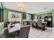 Open-concept kitchen featuring dark cabinets, a breakfast bar, modern appliances, and views to the backyard at 23730 W Hess Ave, Buckeye, AZ 85326