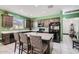 Modern kitchen boasts stainless appliances, a kitchen island with bar seating, and ample cabinet space at 23730 W Hess Ave, Buckeye, AZ 85326