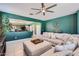 Inviting living room featuring an open layout, with tile flooring, a large sectional, and backyard views at 23730 W Hess Ave, Buckeye, AZ 85326