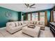 Spacious living room with a large sectional sofa, stylish decor, and views to the backyard at 23730 W Hess Ave, Buckeye, AZ 85326