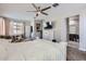 Bright main bedroom with a ceiling fan, carpeted floors, and a seating area at 23730 W Hess Ave, Buckeye, AZ 85326