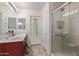 Bathroom with double sink vanity, a full mirror, walk-in shower and neutral flooring at 2519 N 73Rd Dr, Phoenix, AZ 85035