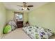 Cozy bedroom with a ceiling fan, neutral carpet and playful decor at 2519 N 73Rd Dr, Phoenix, AZ 85035
