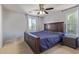 Comfortable bedroom with natural light, ceiling fan, and ample space for furniture at 2519 N 73Rd Dr, Phoenix, AZ 85035