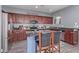Charming kitchen featuring stainless appliances, wood cabinets, and an island with barstool seating at 2519 N 73Rd Dr, Phoenix, AZ 85035