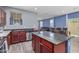 Open-concept kitchen with stainless appliances, wood cabinets, granite countertops, and a view to the living room at 2519 N 73Rd Dr, Phoenix, AZ 85035