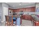 Charming kitchen featuring stainless appliances, wood cabinets, and an island with barstool seating at 2519 N 73Rd Dr, Phoenix, AZ 85035