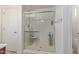 Bright bathroom featuring glass-enclosed walk-in shower with built-in bench and showerhead at 2519 N 73Rd Dr, Phoenix, AZ 85035