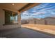 Covered patio opens to a spacious backyard with block fencing and desert landscaping; a blank canvas for your dream oasis at 262 S 164Th Dr, Goodyear, AZ 85338