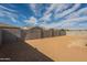 Large, flat backyard with block fencing providing privacy and desert landscaping for low maintenance and future design at 262 S 164Th Dr, Goodyear, AZ 85338