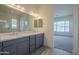 Bathroom featuring a double vanity with modern fixtures, gray cabinets, and wood-look tile flooring at 262 S 164Th Dr, Goodyear, AZ 85338