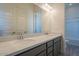 Bathroom featuring a double vanity with modern fixtures, gray cabinets, and wood-look tile flooring at 262 S 164Th Dr, Goodyear, AZ 85338