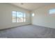 Bright bedroom with carpet flooring, large window, and ample natural light at 262 S 164Th Dr, Goodyear, AZ 85338