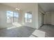 Bright dining room featuring large windows, modern chandelier, and wood-look tile flooring at 262 S 164Th Dr, Goodyear, AZ 85338