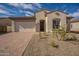 Inviting single-story home featuring a neatly paved driveway and low maintenance desert landscaping at 262 S 164Th Dr, Goodyear, AZ 85338