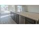 Elegant kitchen island with sleek gray cabinetry, stainless steel dishwasher, and white quartz countertop at 262 S 164Th Dr, Goodyear, AZ 85338