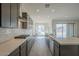 Spacious kitchen with a cooktop, a large island, sleek countertops, and gray cabinets at 262 S 164Th Dr, Goodyear, AZ 85338