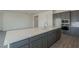 Open-concept kitchen showcasing a large island, stainless steel appliances, and stylish gray cabinets at 262 S 164Th Dr, Goodyear, AZ 85338